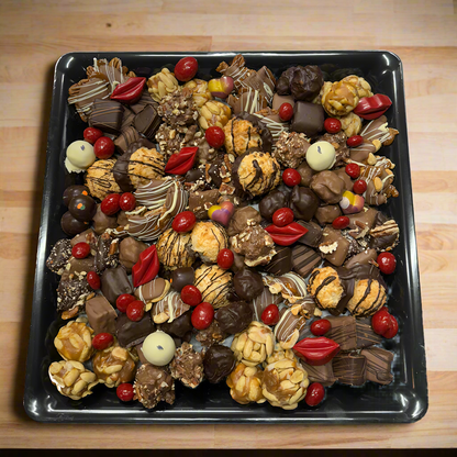 Large black tray with a collection of confections